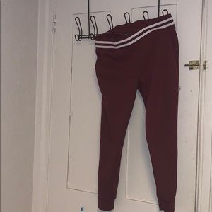 Burgundy sweatpants with white stripe